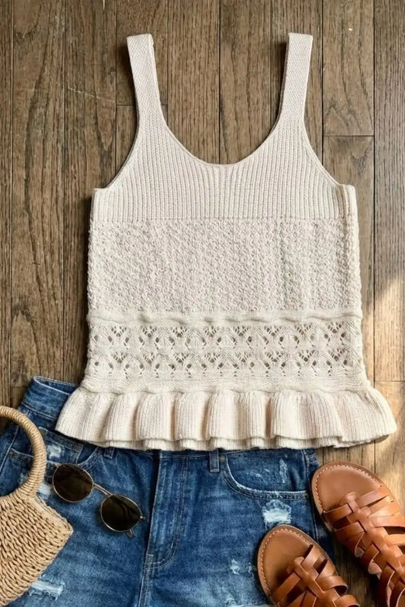 Beige ribbed knit tank top with a lace pattern and ruffled hem.